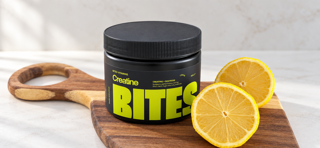 Bites Vitamins lemon creatine supplement with lemon slices on a wooden board.
